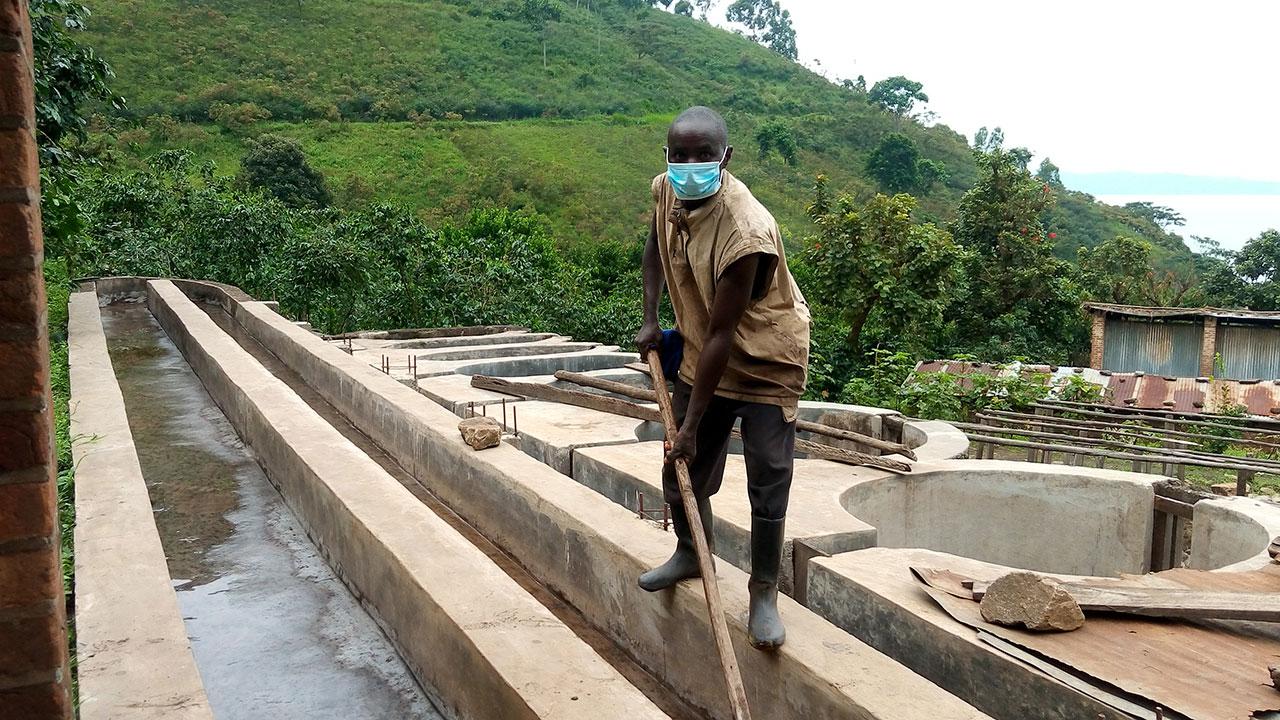 Cleaning the grading channel at the Kazo washing station in Kalehe